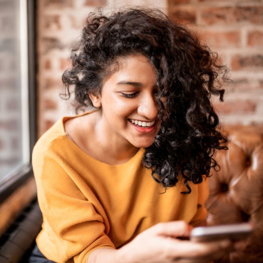 woman smilling at phone