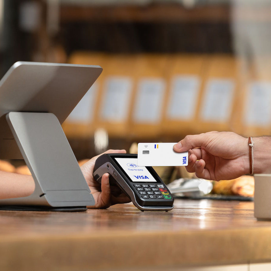 person paying contactless with Visa card