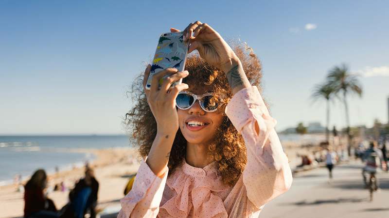 Woman taking a photo at the seafront